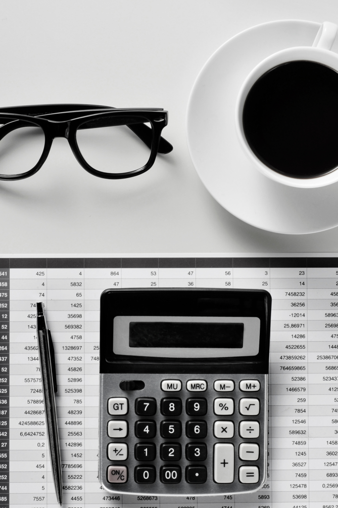 Monthly Bookkeeping Services. Image of calculator and accounting book